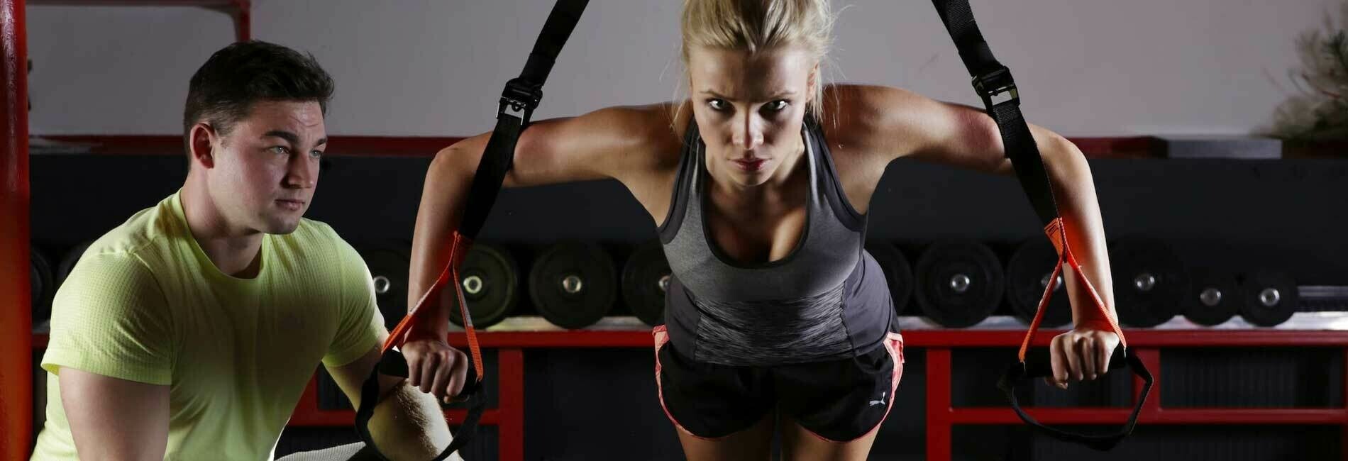 Personal Trainer Helping Woman